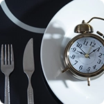 plato con tenedor cuchillo y despertador
